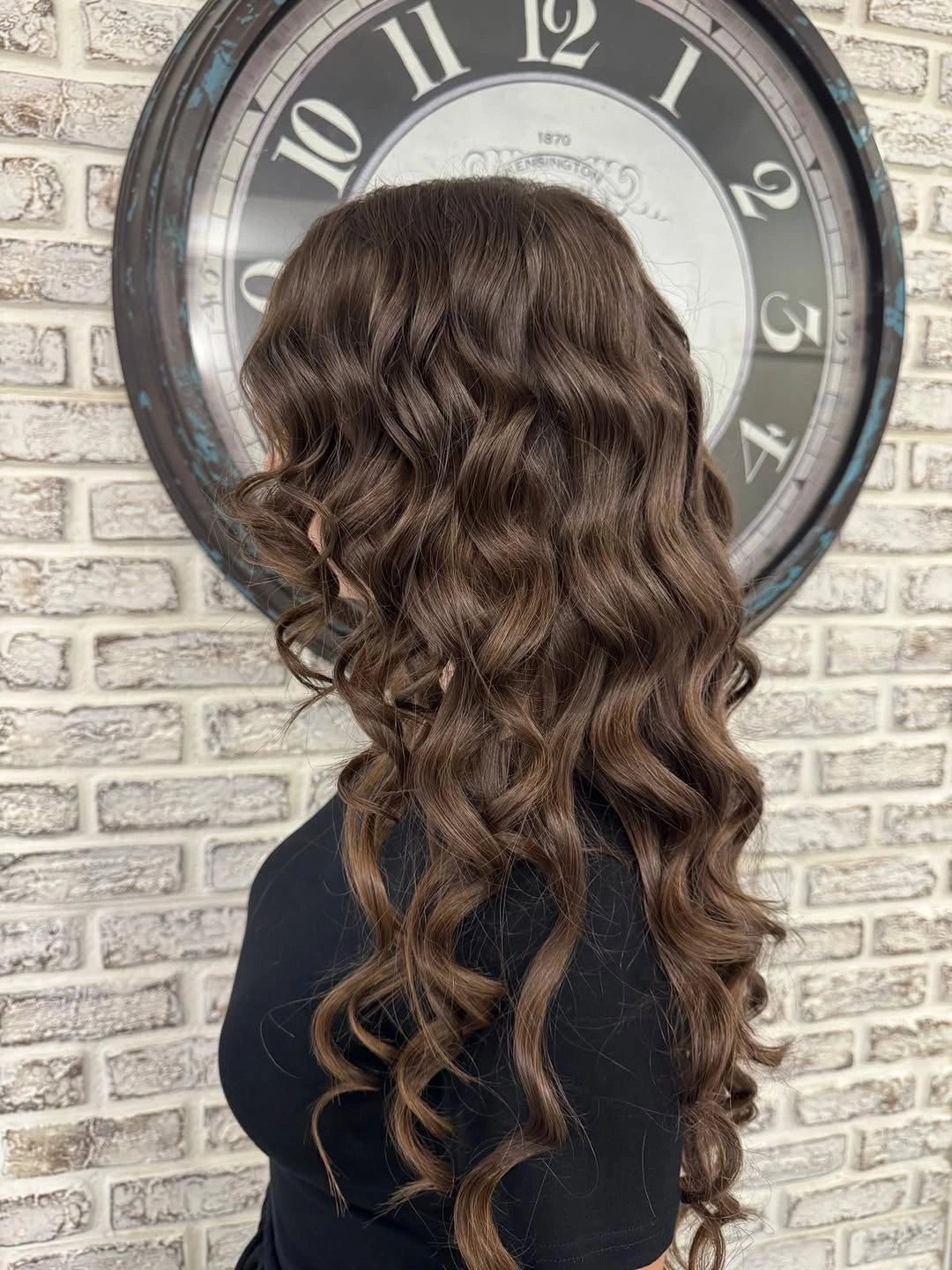 Long cocoa brown hair with defined curls and subtle warm reflections