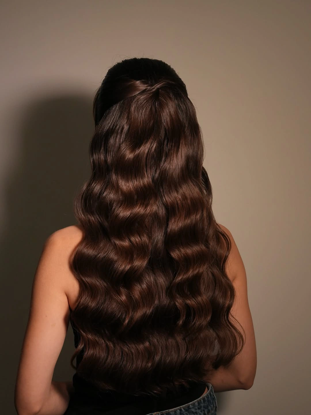 Very long brunette hair with half-up crown and flowing waves