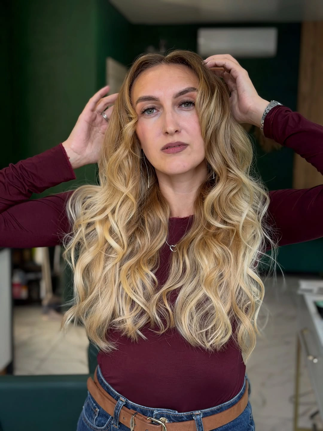Long blonde hair with high-starting loose waves and center part