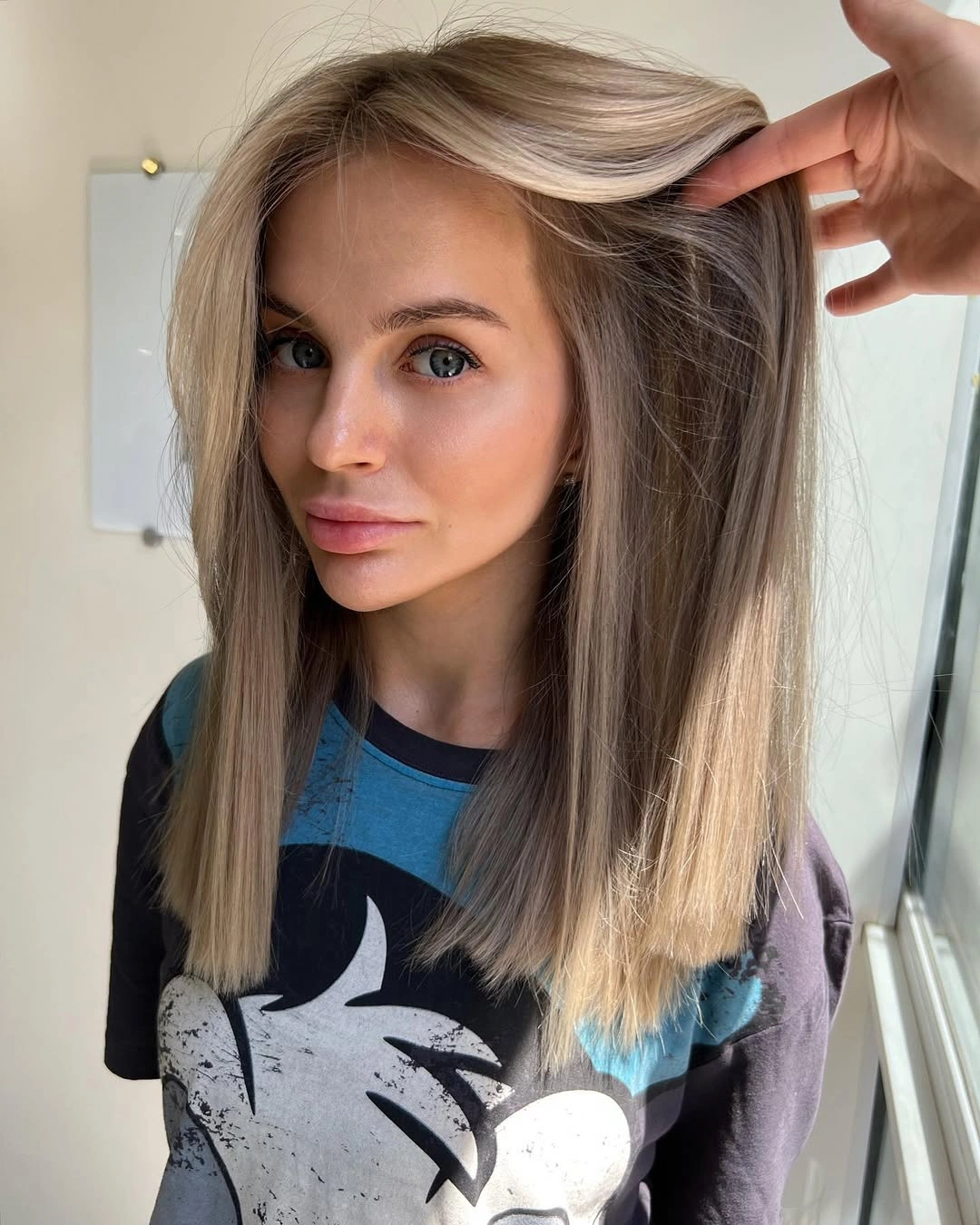 Long straight light hair with darker roots and brighter front pieces