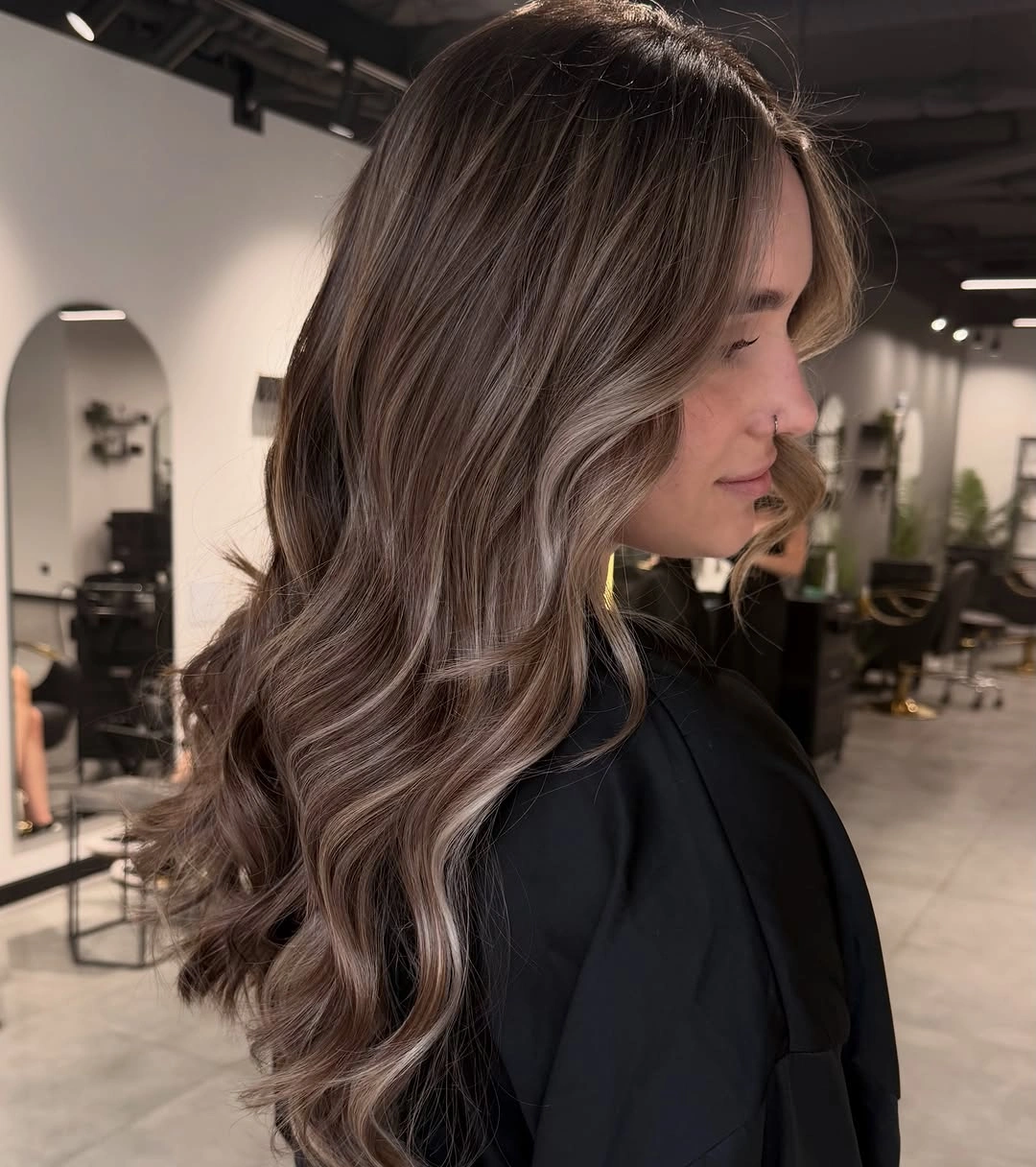 Long brunette hair with dimensional color and broad flowing waves