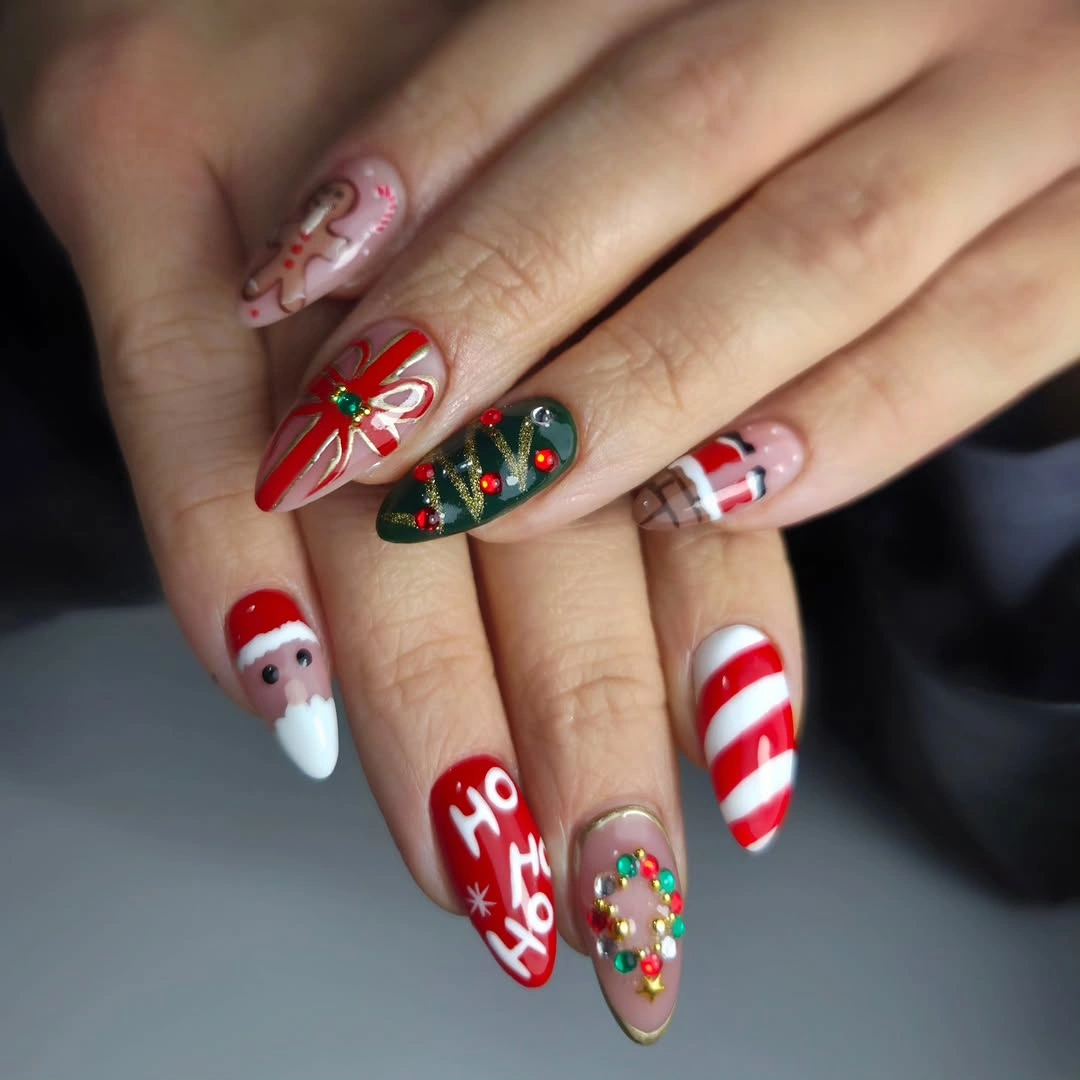 Long pointed Christmas nails with Santa, candy canes, lettering, and colorful decorations