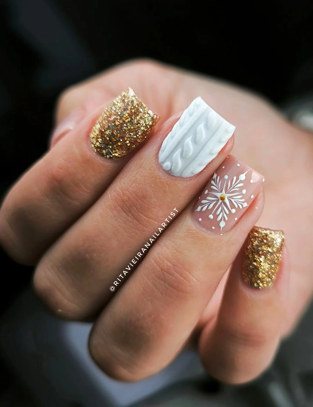 Short square nails with gold glitter, white cable texture, and snowflake art