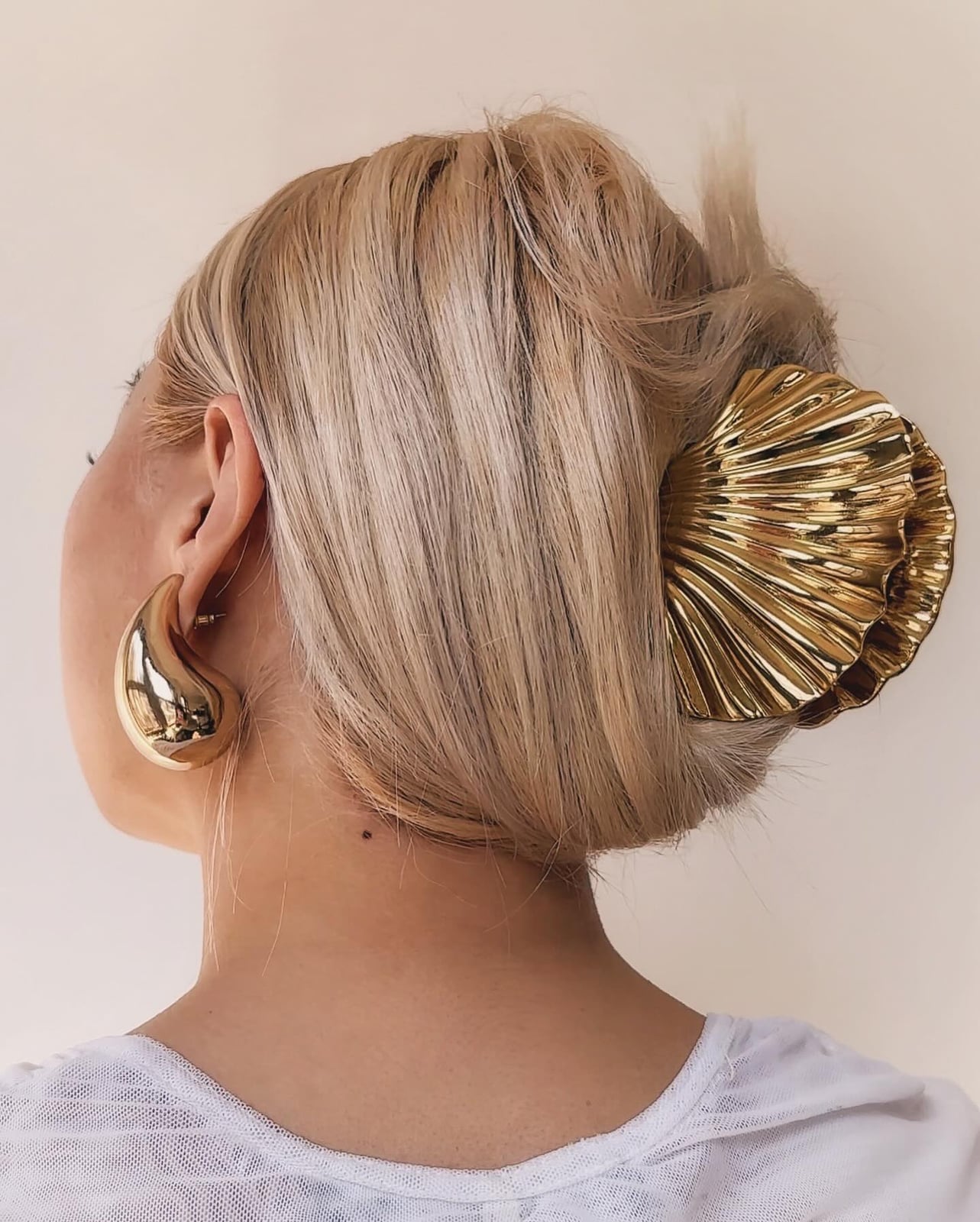 Sleek Blonde Updo With Gold Hair Clip — Elegant Updo Inspo