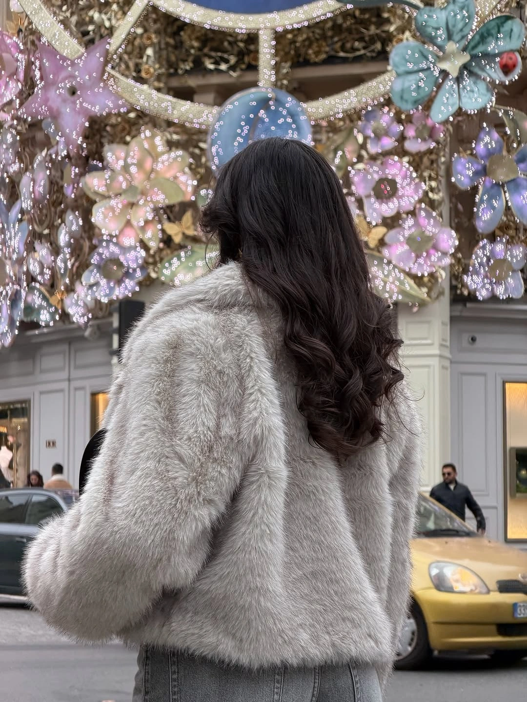 Cropped pale gray plush jacket with gray denim viewed from behind
