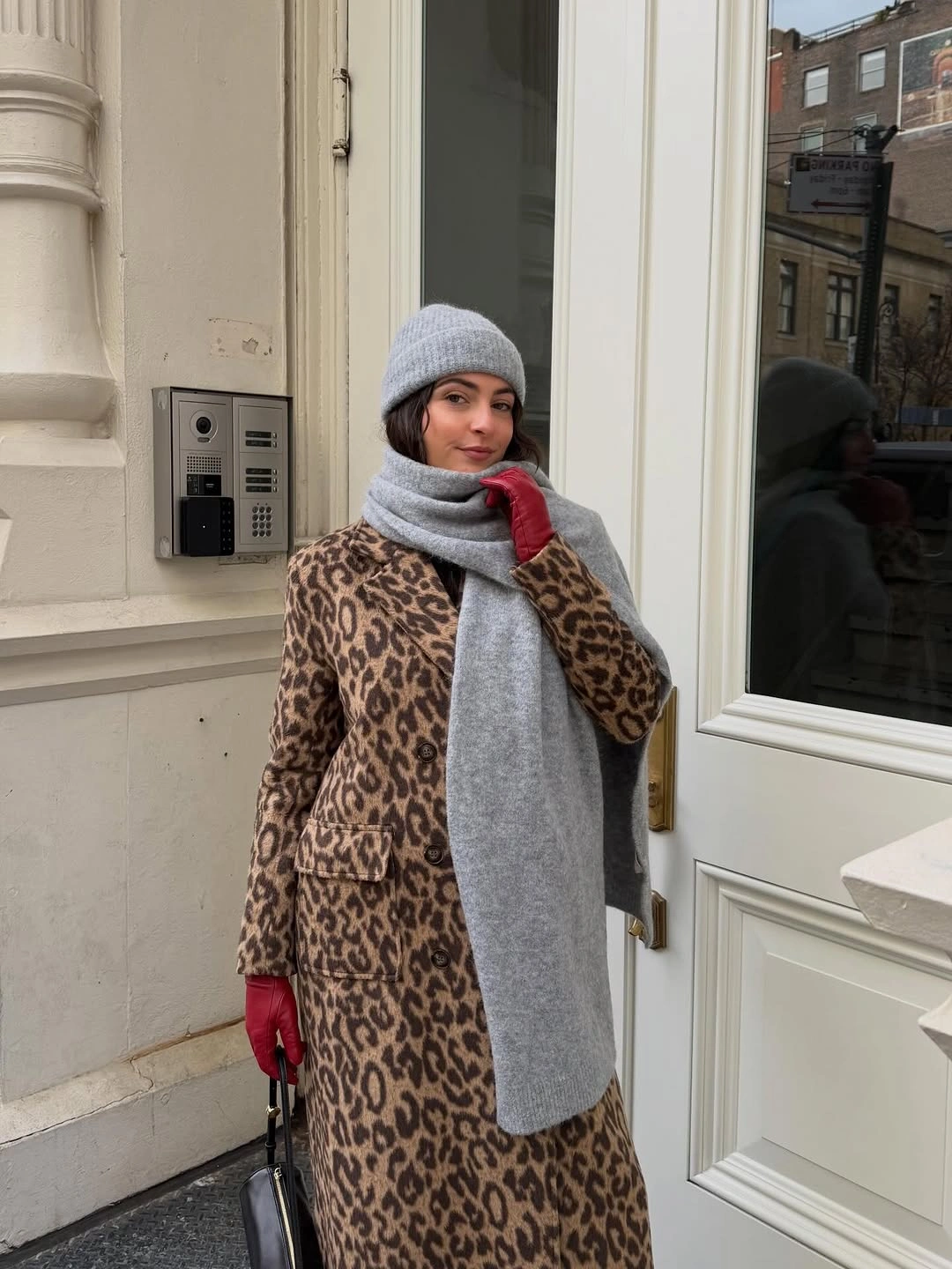 Long leopard print coat with oversized gray scarf, beanie, and red gloves