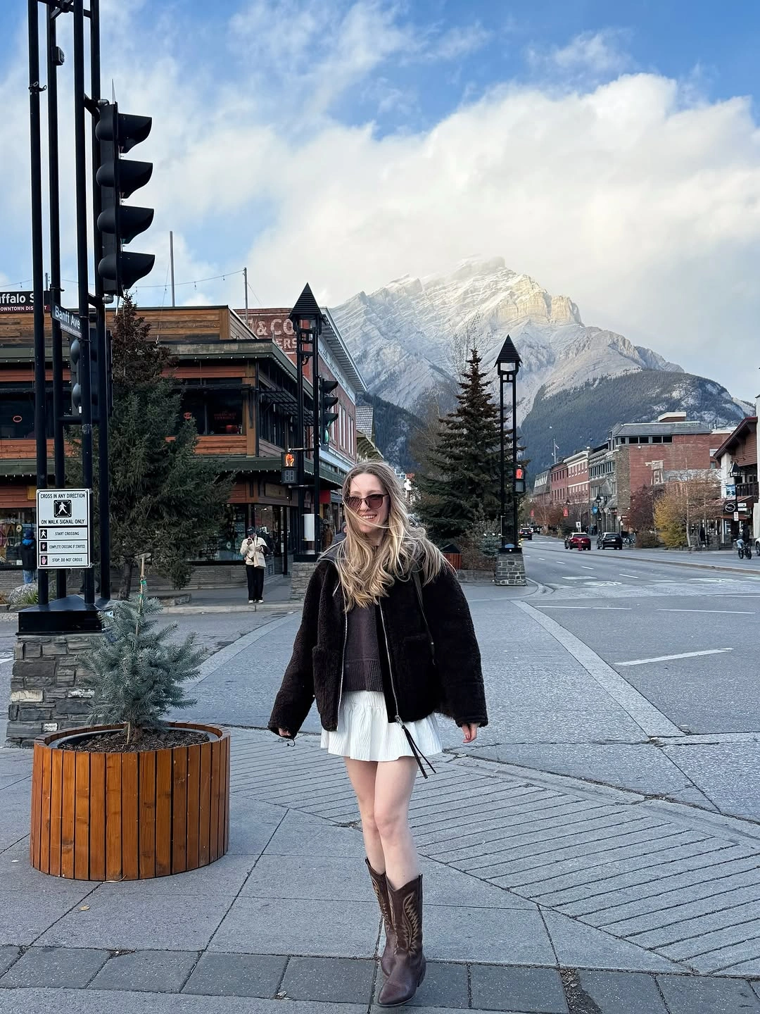 Black plush jacket with white pleated hem and brown Western boots