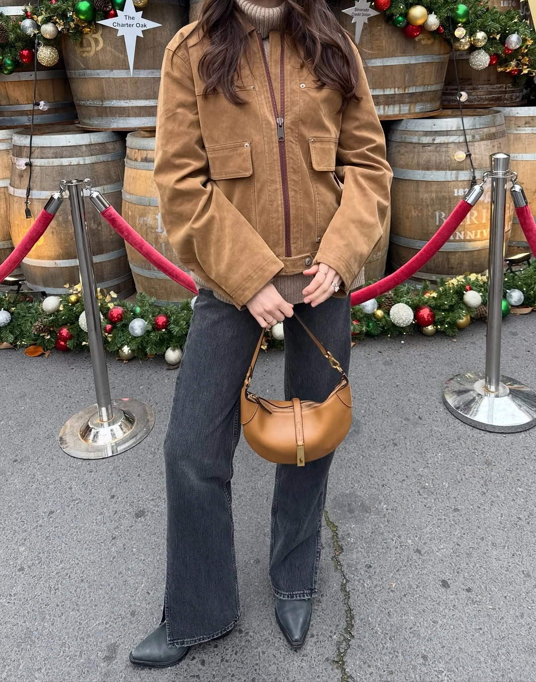 Tan utility jacket with charcoal wide-leg jeans and caramel handbag