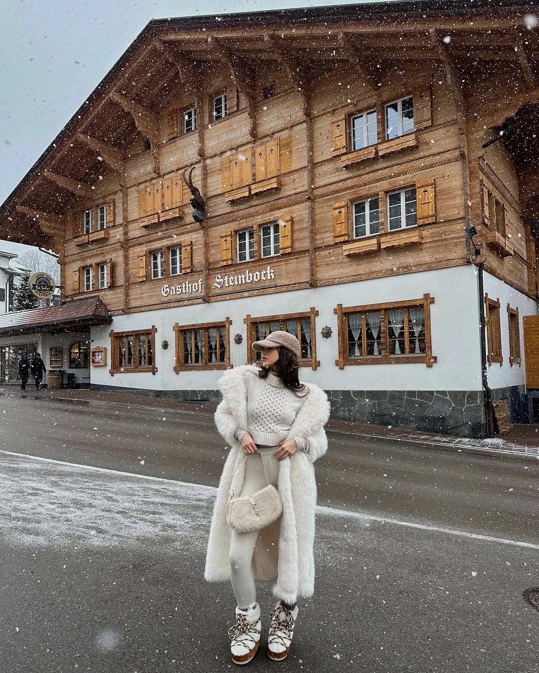 Long white textured coat with cream knit, beige cap, and patterned boots