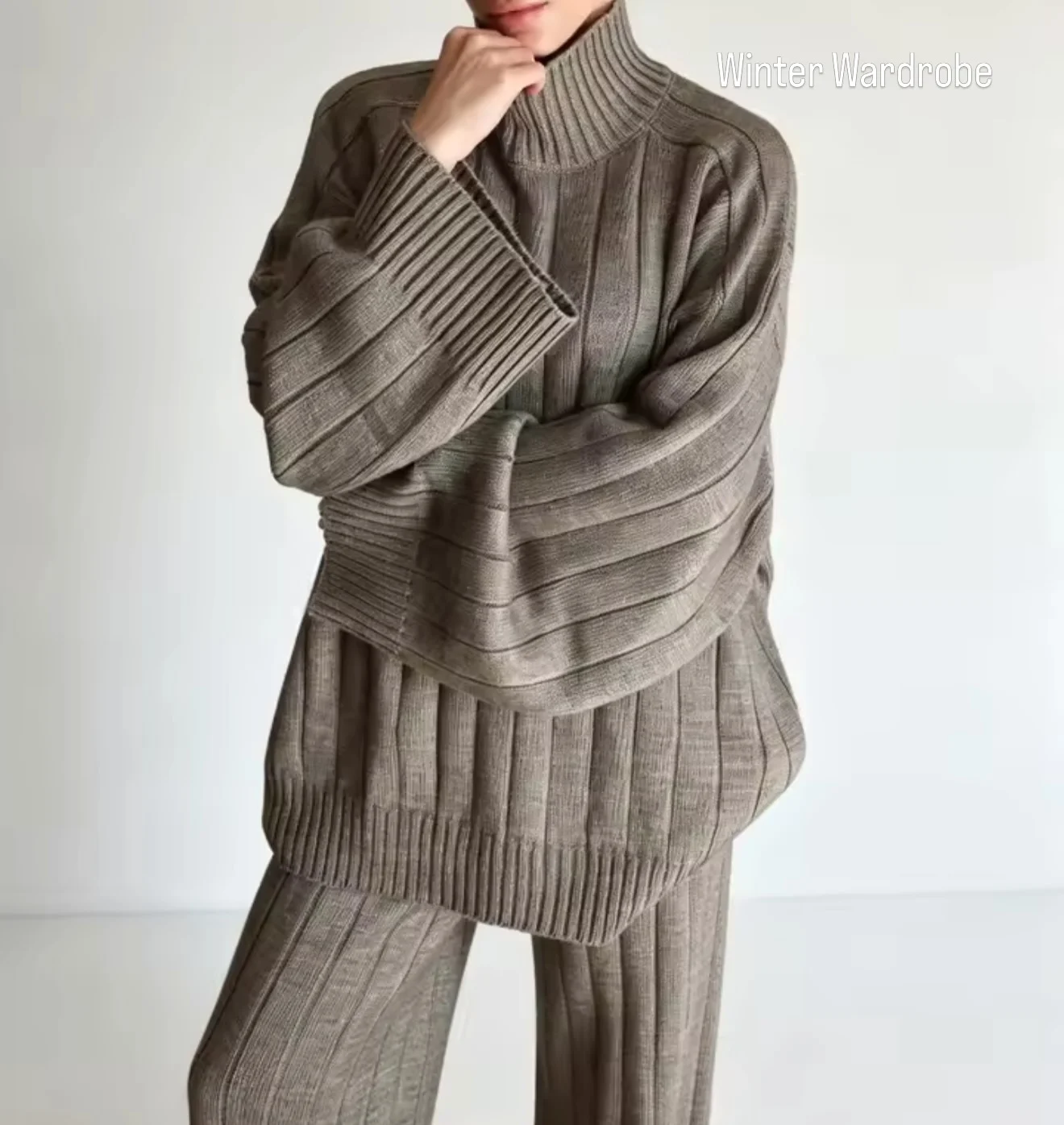 Taupe gray ribbed turtleneck sweater with wide sleeves and matching knit trousers