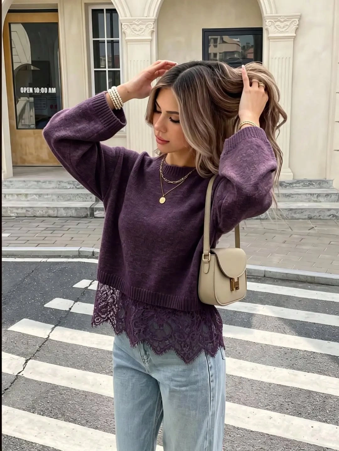 Loose purple sweater with dark lace hem pale jeans and cream shoulder bag