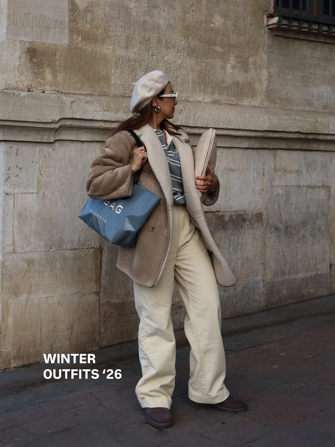 Beige beret and coat with striped top cream trousers and blue tote