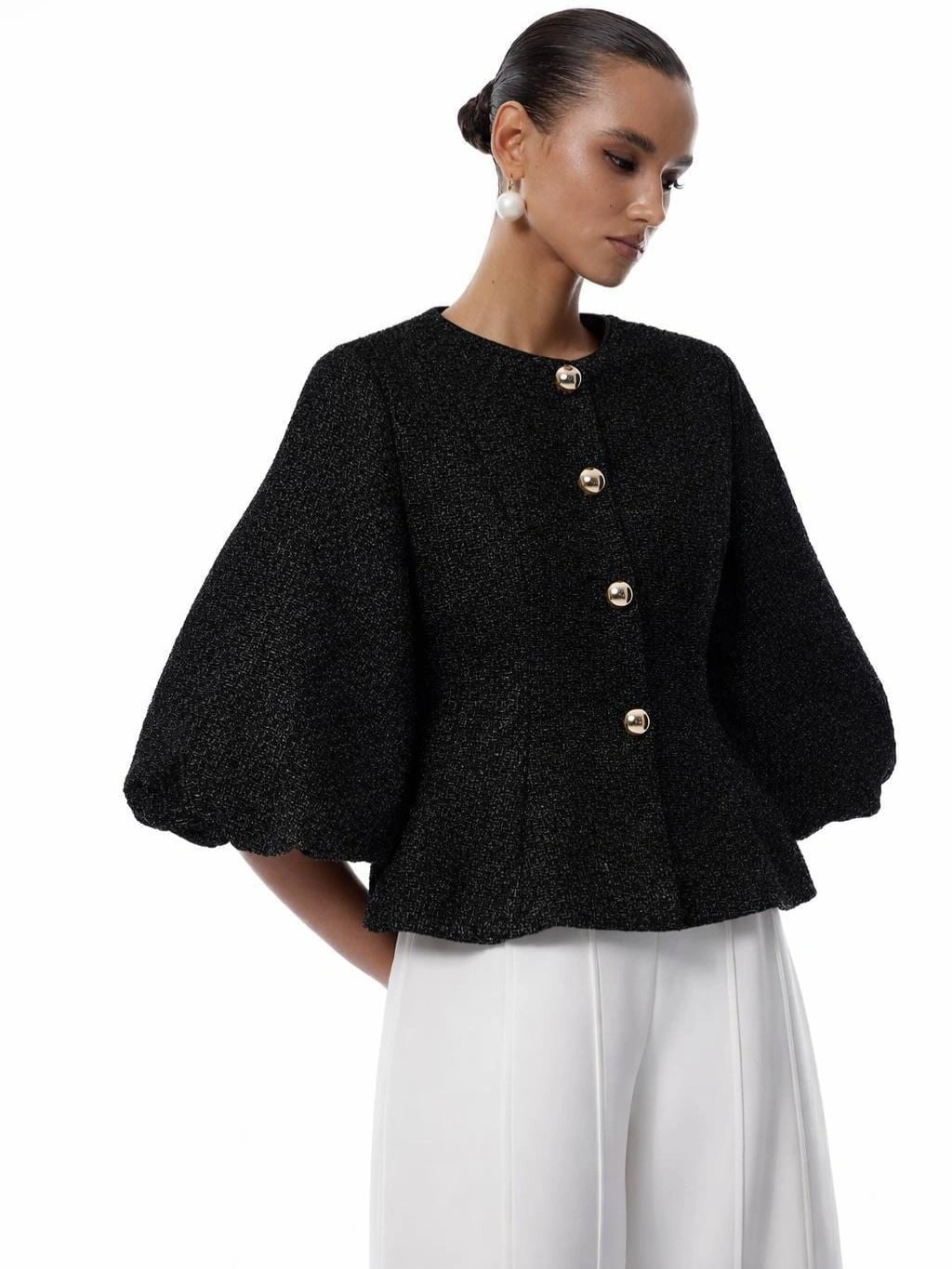 Cropped black jacket with rounded sleeves metallic buttons and wide white trousers