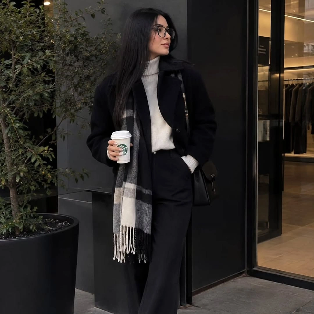 Long black coat white high neck sweater gray plaid scarf and trousers