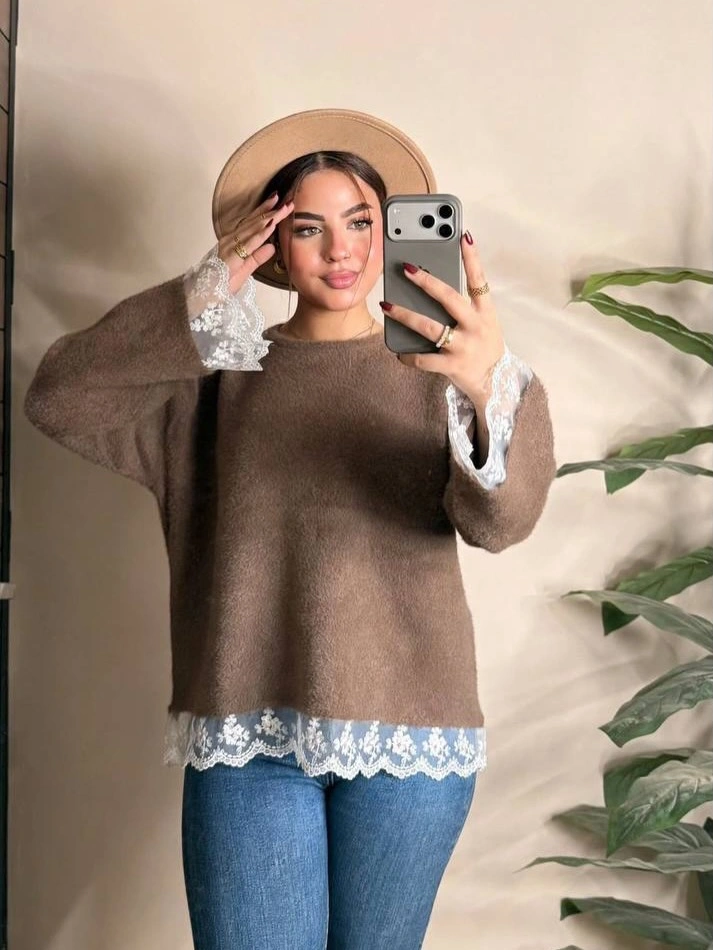 Brown sweater with white lace edging blue jeans and beige beret
