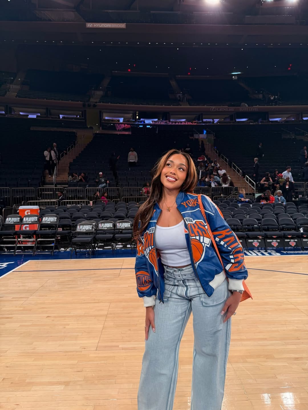 Bomber Jacket Layered Over a Tank Top with Wide-Leg Jeans Bomber Jacket Layered Over a Tank Top with Wide-Leg Jeans — Simple Basketball Game Outfits