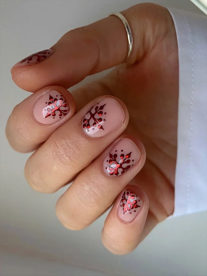Short Oval Nude With Red Snowflake Accents Short Oval Nude With Red Snowflake Accents — Simple Nail Designs