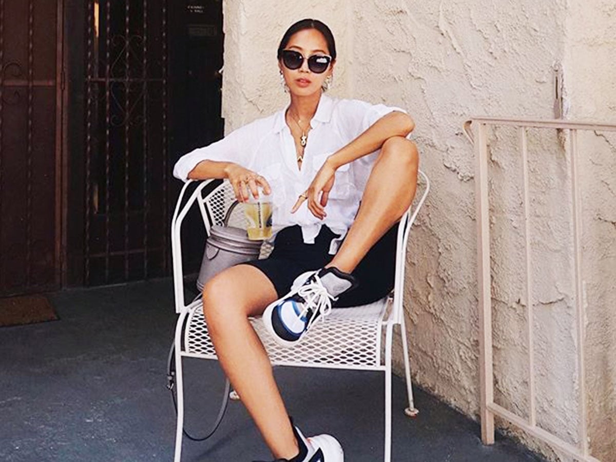 White Button-Up Over Athletic Shorts with Layered Necklaces — Trendy Athleisure Outfits