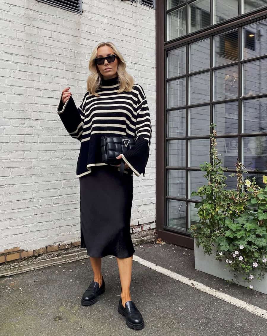 Chunky Black Loafers With Striped Sweater And Slip Skirt — Trendy Black Loafers Outfit