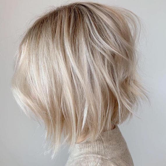 Chin Length Platinum Blonde Textured Bob With Wispy Bangs — Trendy Blonde Bob