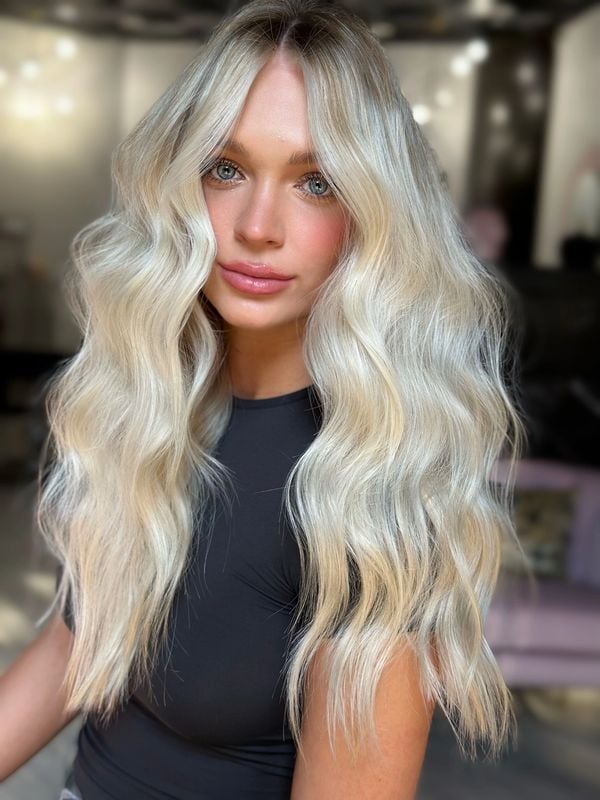 Mid-Back Ash Blonde With Root Shadow And Babylights — Trendy Blonde Wavy Hair