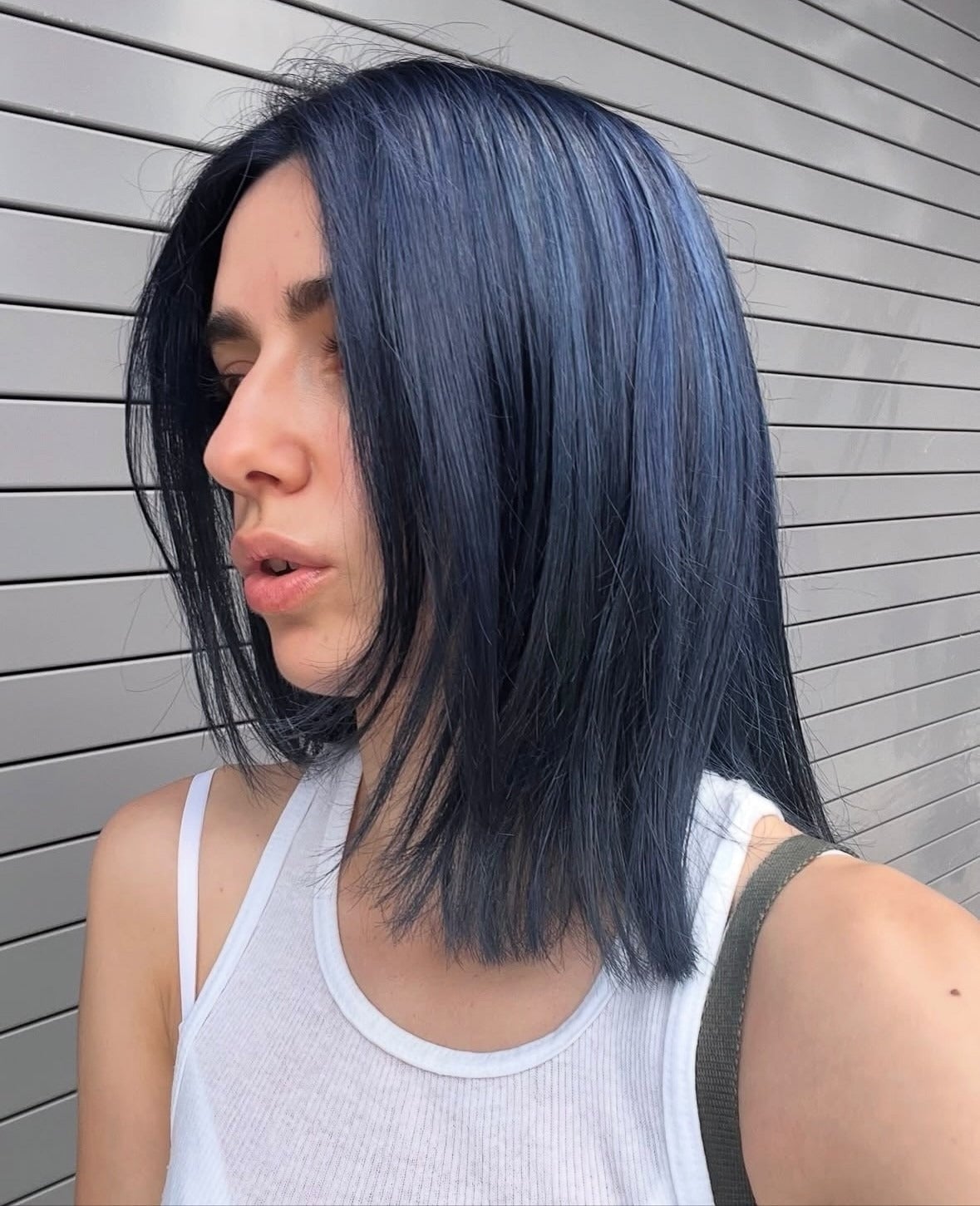 Collarbone Length Light Blue With Lighter Streaks and Curtain Bangs — Trendy Blue Hair Color