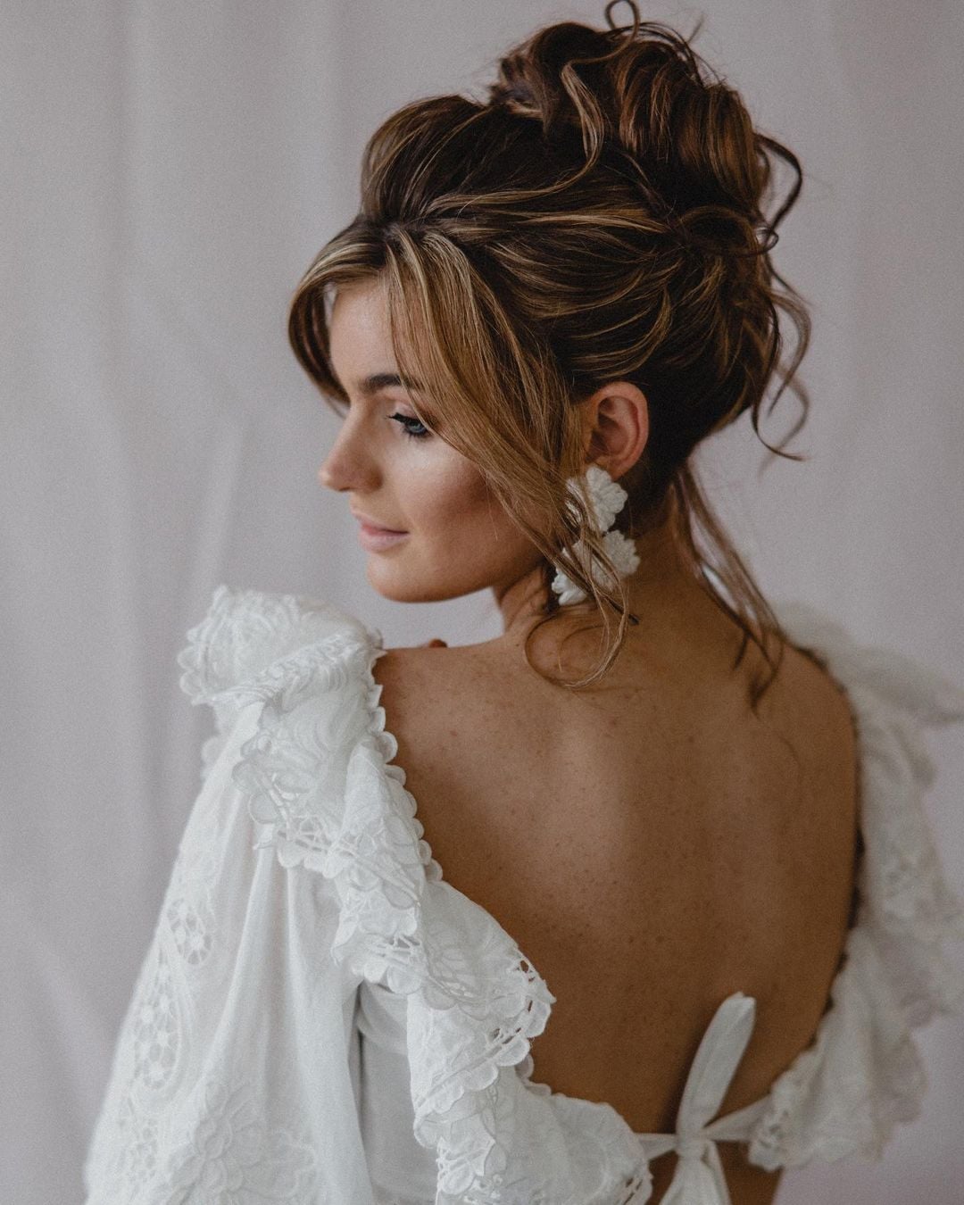 Dark Brown High Bun With Caramel Highlights — Trendy Bridal Hair
