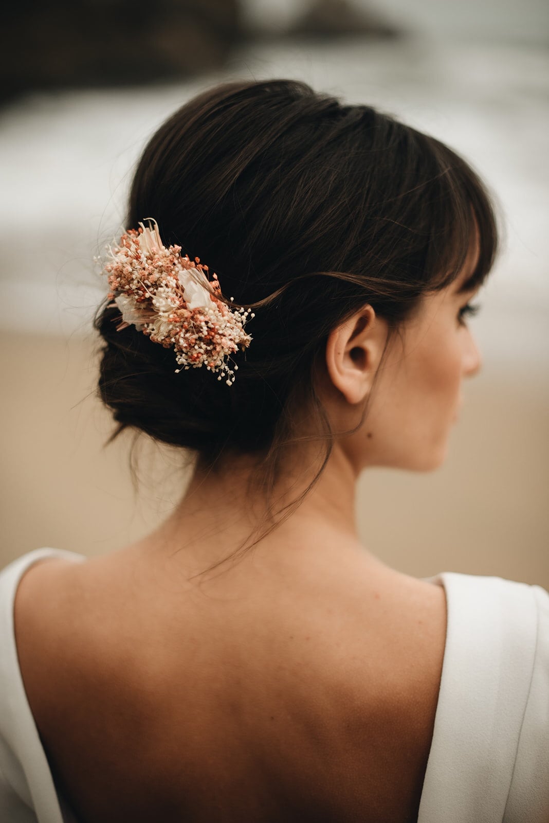 Dark Brown Low Bun With Floral Accessory, Close-Up Take — Trendy Bridal Hair