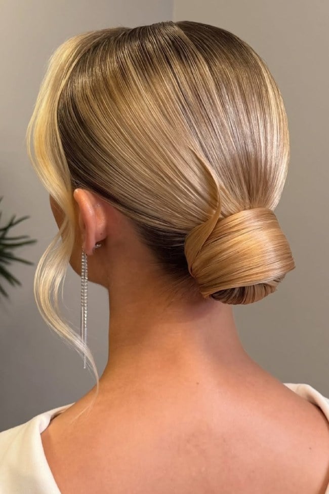 Sleek Low Bun With Face-Framing Tendrils — Trendy Bridal Hairstyles
