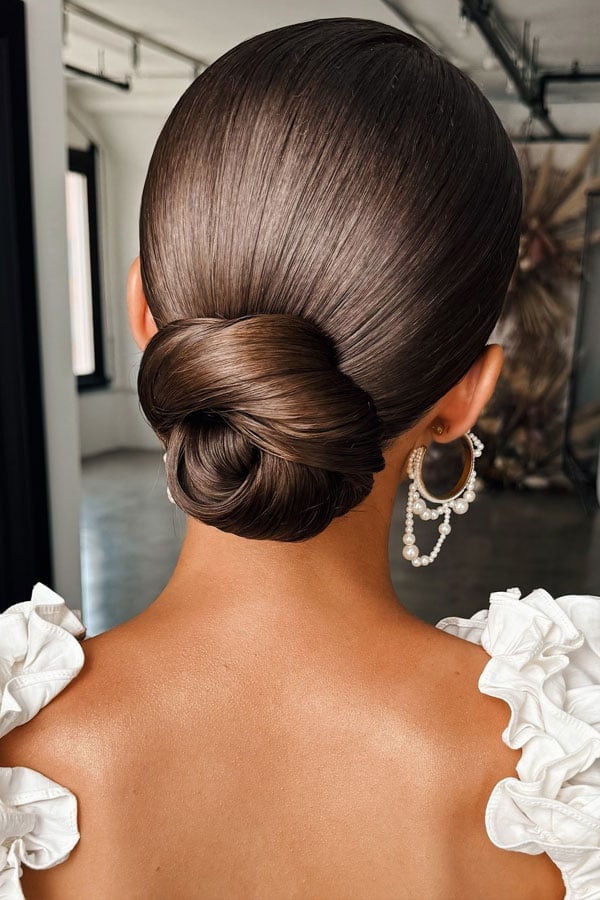 High-Gloss Dark Brown Sleek Low Bun — Trendy Bridesmaid Hairstyles Updo