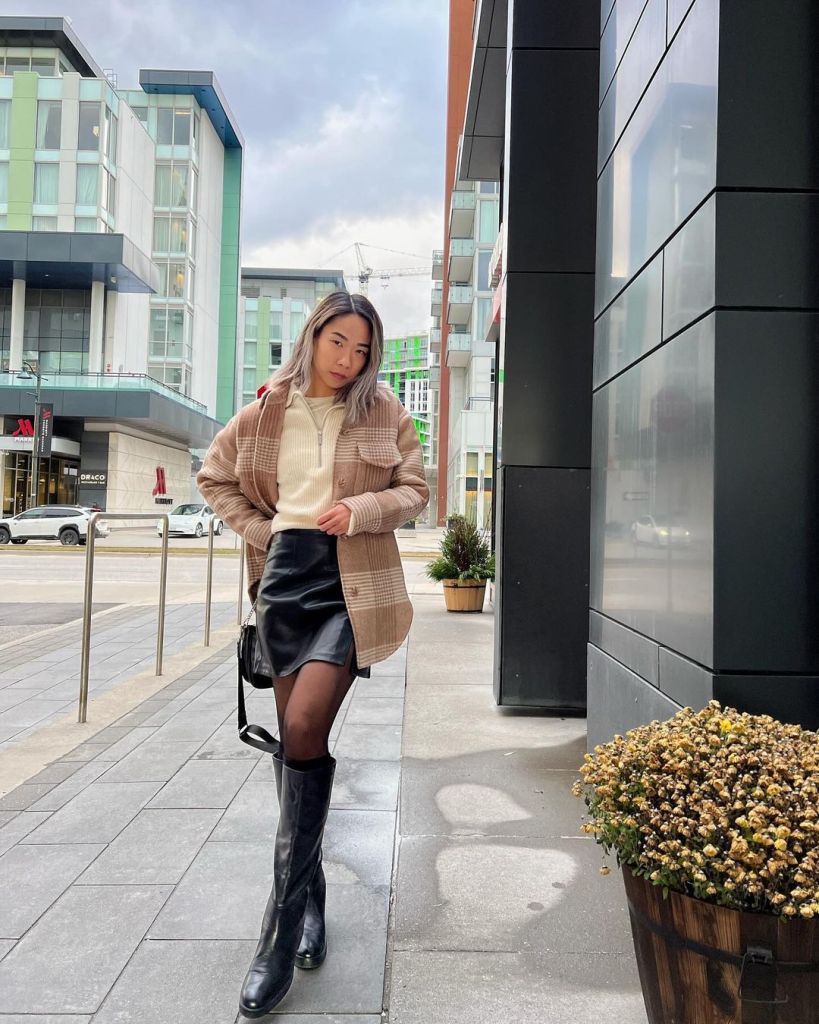 Plaid Jacket Over Quarter-Zip Sweater With Mini Skirt — Trendy Brown Leather Skirt Outfit