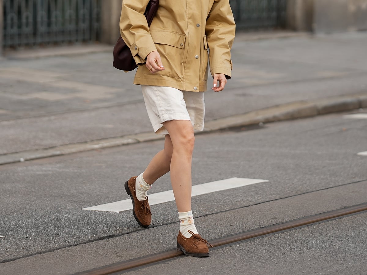 Brown Suede Loafers with Utility Jacket and White Shorts — Trendy Brown Loafers Outfit