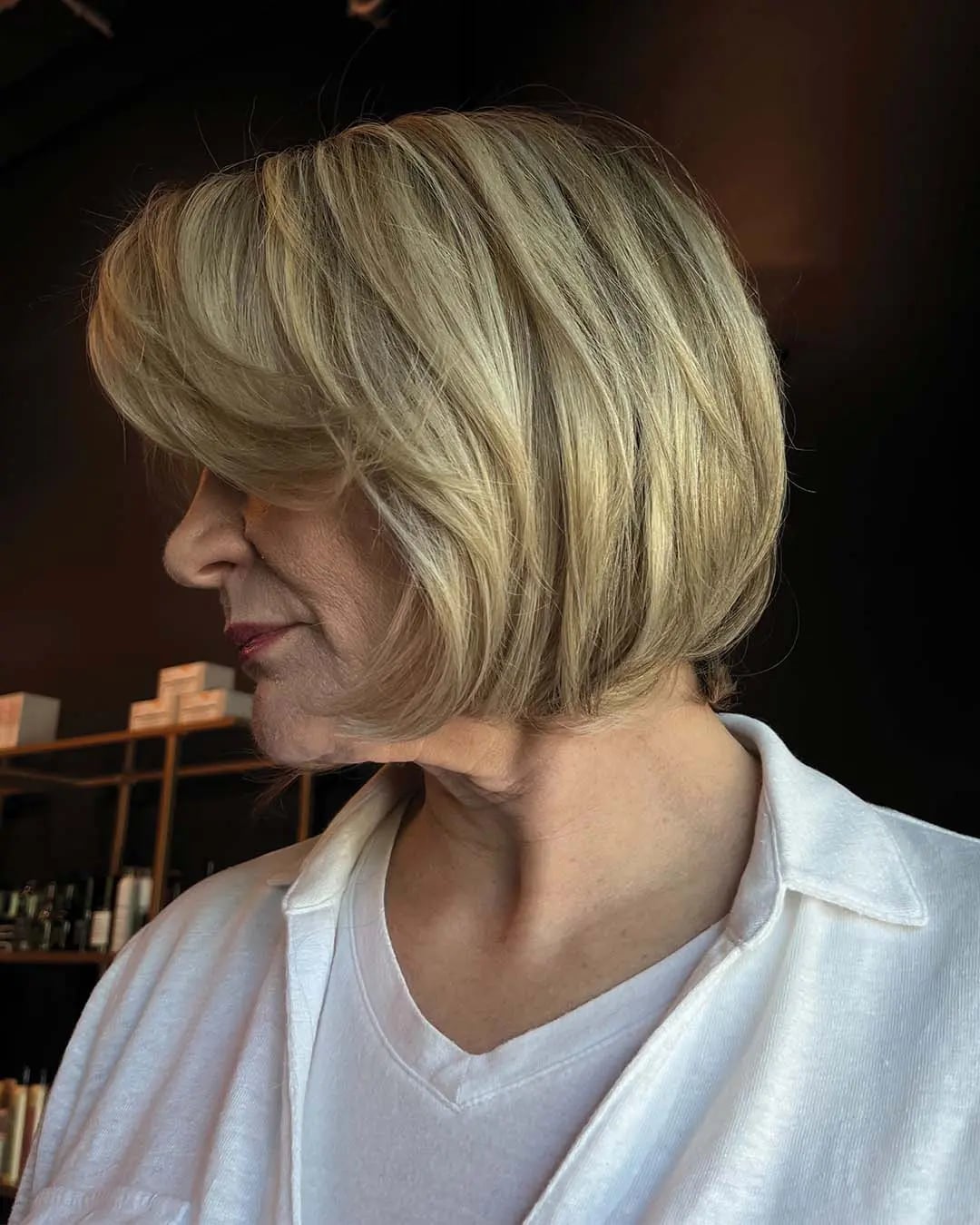 Blonde Bob With Layers And Side Swept Bangs, Close-Up Take — Trendy Chin Length Hair