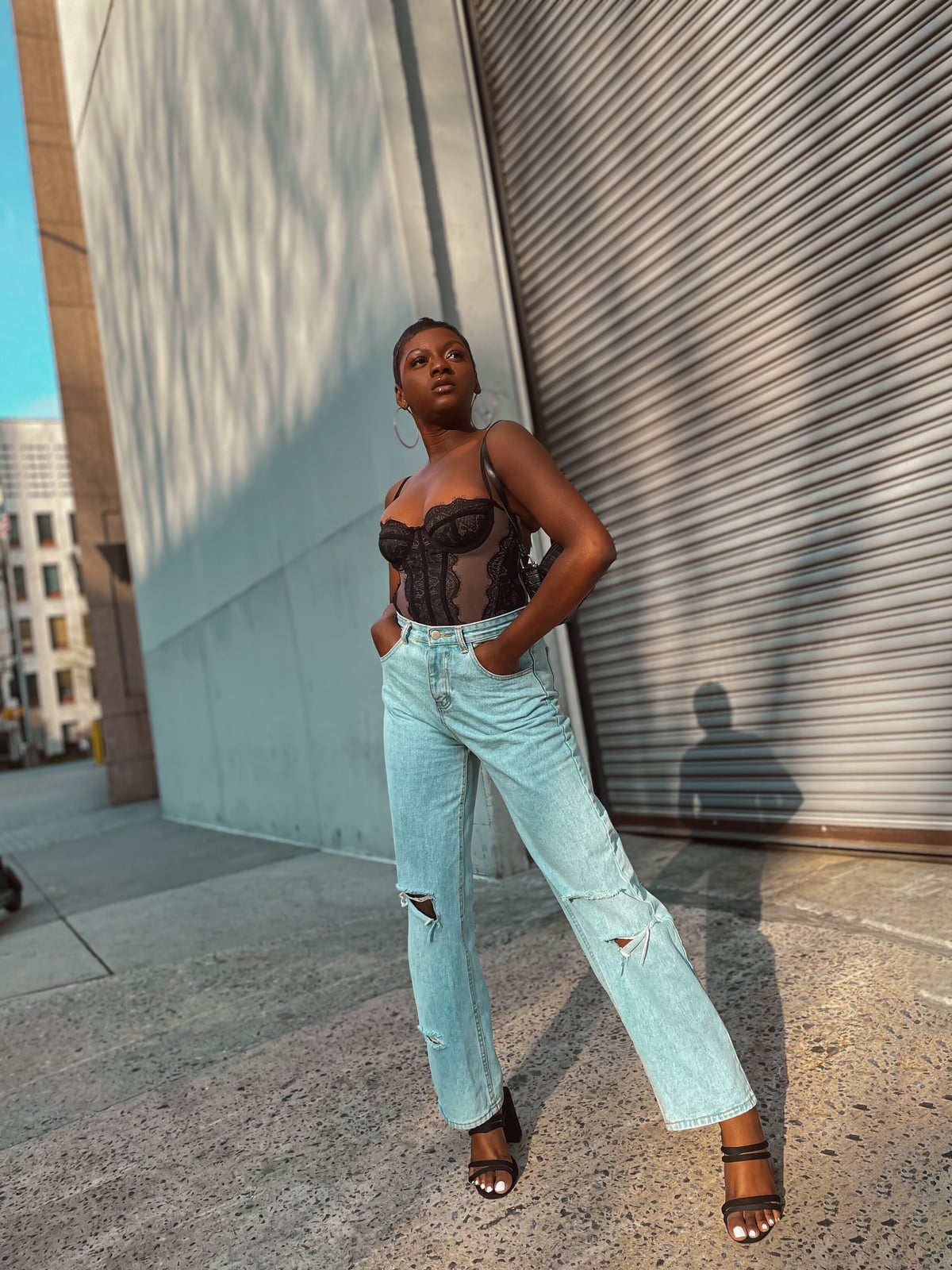 Black Lace Corset With Ripped Jeans and Heels and Large Hoop Earrings Black Lace Corset With Ripped Jeans and Heels and Large Hoop Earrings — Trendy Corset Top Outfits