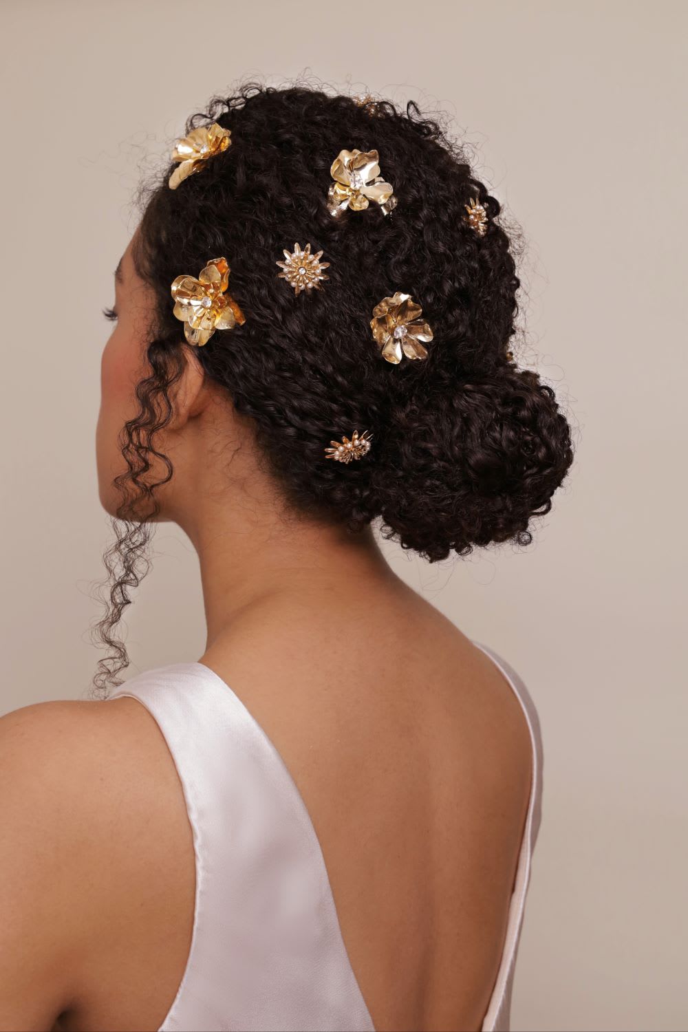 Low Dark Brown Updo With Gold Accessories Low Dark Brown Updo With Gold Accessories — Trendy Curly Updo