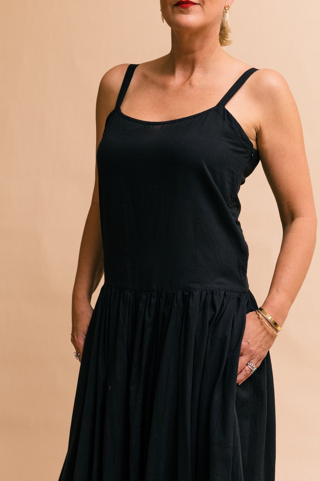 Black Cotton Gathered Skirt Drop Waist Midi Dress With Gold Bracelets Black Cotton Gathered Skirt Drop Waist Midi Dress With Gold Bracelets — Trendy Drop Waist Dresses