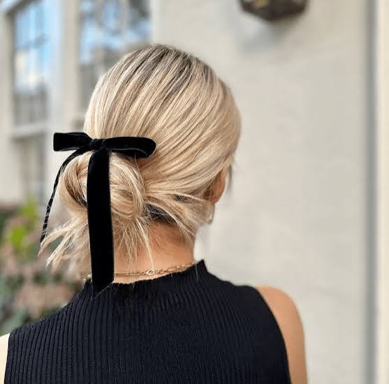 Blonde Low Bun With Black Velvet Bow Blonde Low Bun With Black Velvet Bow — Trendy Formal Hair