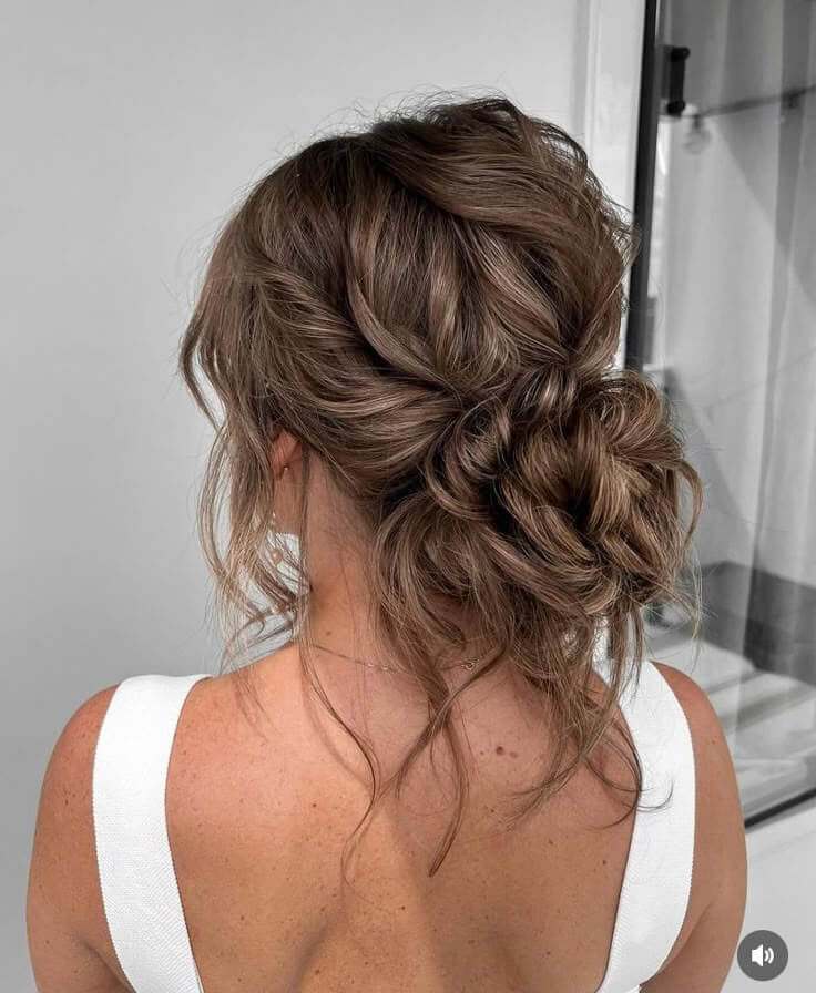 Light Brown Loose Low Bun With Wispy Pieces Light Brown Loose Low Bun With Wispy Pieces — Trendy Formal Hair