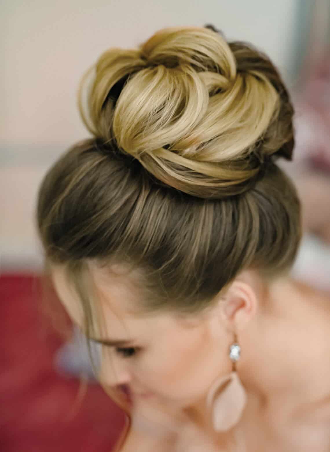 High Bun With Wavy Blonde Highlights High Bun With Wavy Blonde Highlights — Trendy Formal Updos