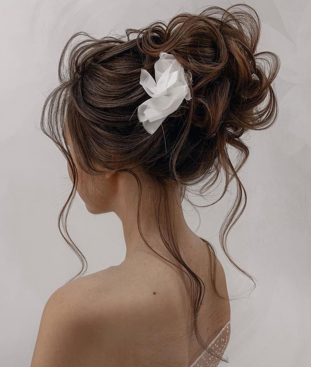 High Messy Updo With Loose Tendrils High Messy Updo With Loose Tendrils — Trendy Formal Updos