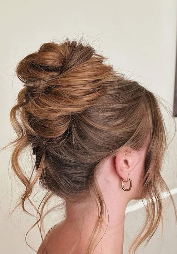 High Messy Bun With Textured Pieces High Messy Bun With Textured Pieces — Trendy Formal Updos