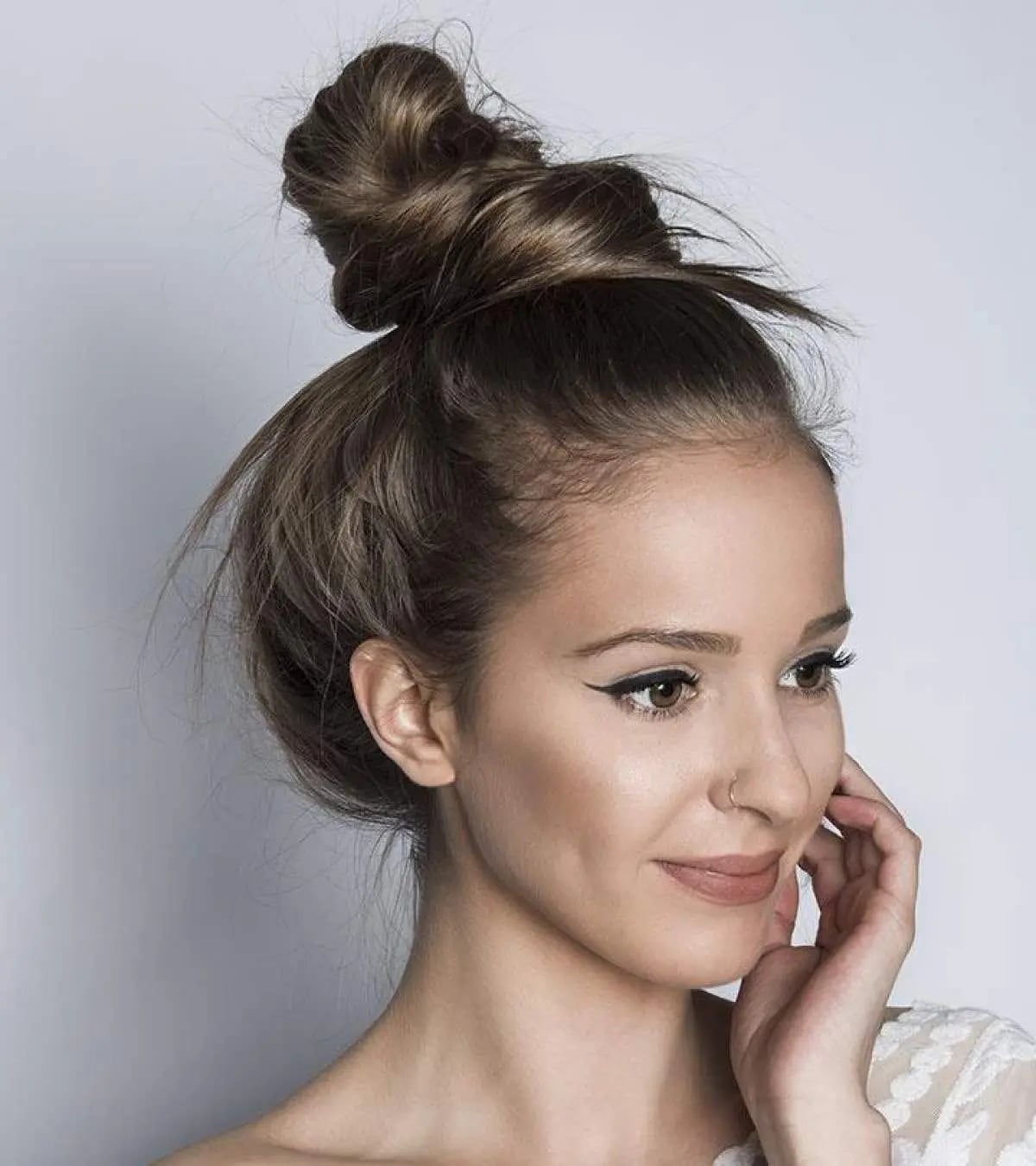 High Messy Bun With Loose Strands — Trendy High Bun Hairstyles