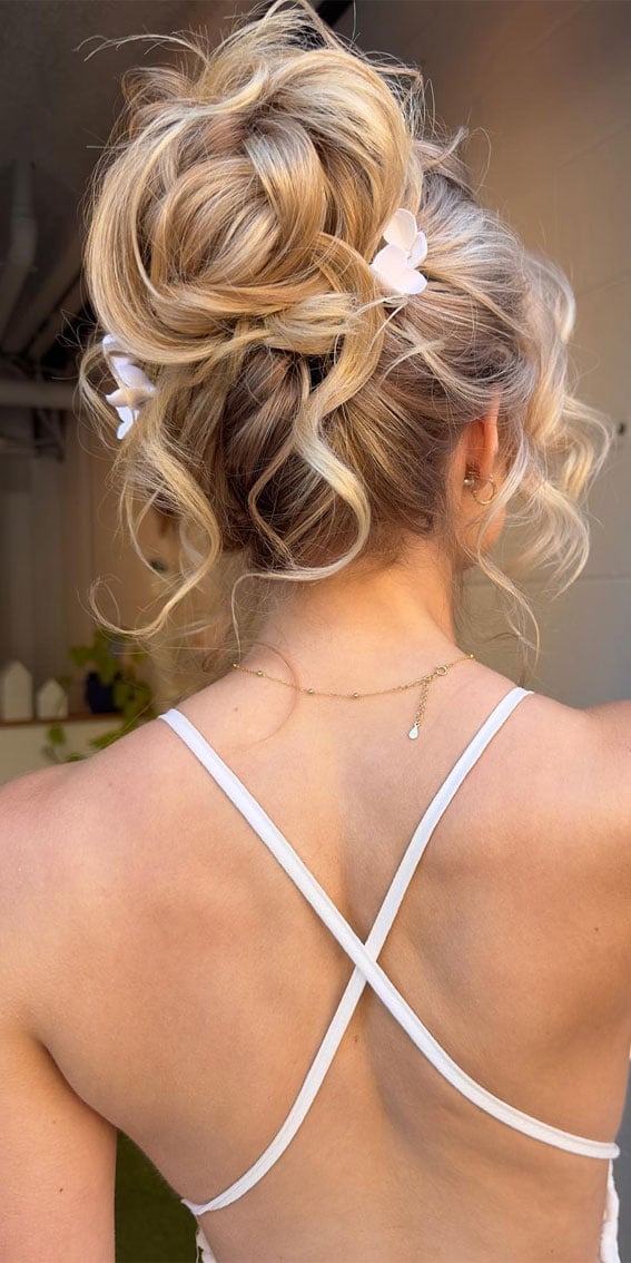 Textured Blonde Balayage Updo With Flowers — Trendy High Bun Hairstyles