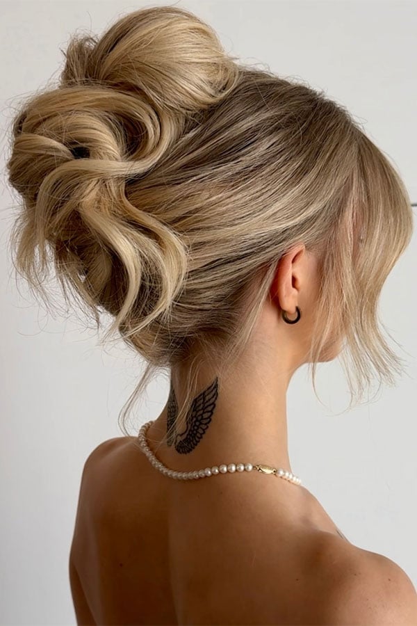Voluminous Curled Blonde Updo With Face-Framing Pieces — Trendy High Bun Hairstyles