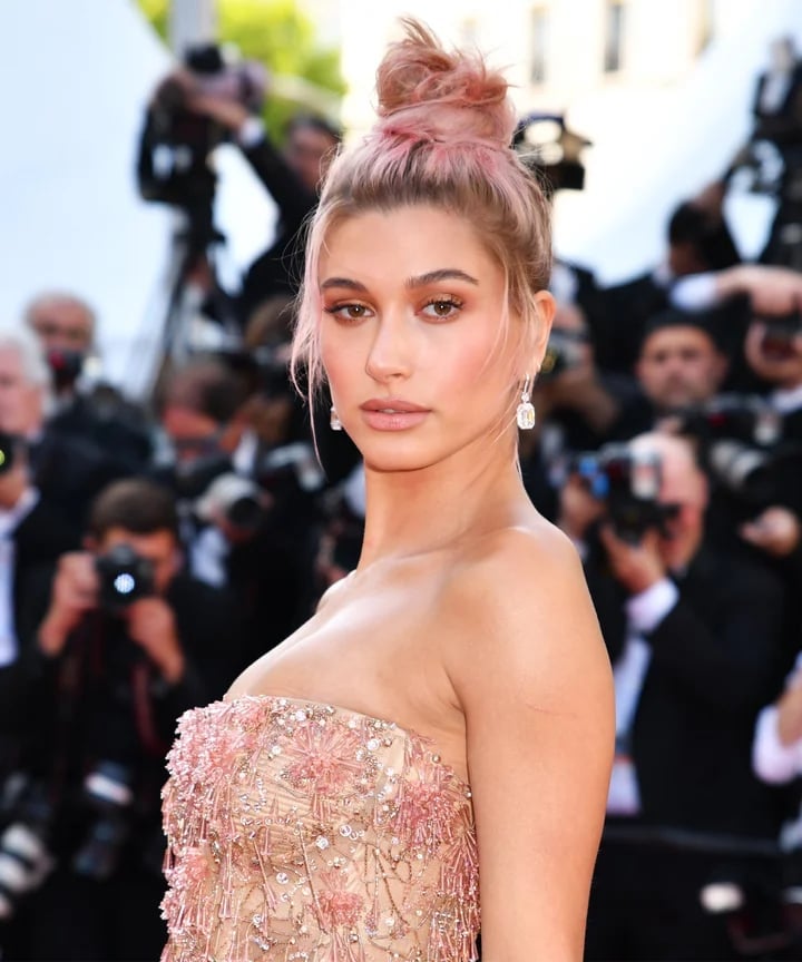 High Messy Pink Bun With Curtain Bangs — Trendy High Bun Hairstyles
