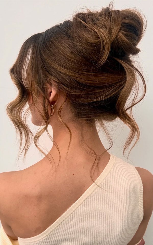 Voluminous Messy Updo With Loose Tendrils — Trendy High Bun Hairstyles