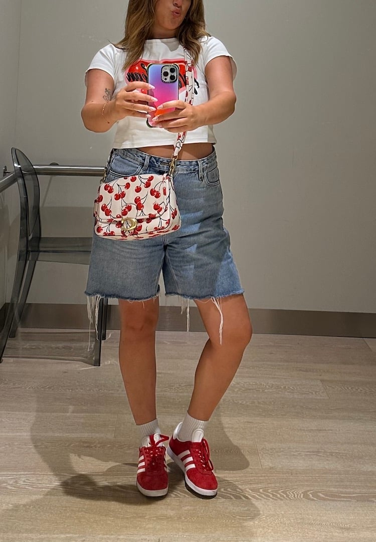 Distressed Jorts With Graphic T-Shirt And Red Sneakers, Close-Up Take — Trendy Jorts Outfits