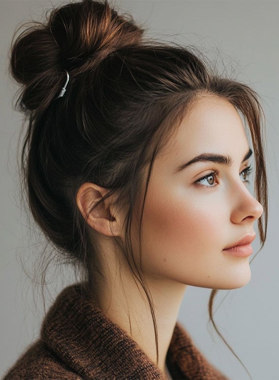 Dark Brown High Messy Bun With Loose Strands and Face-Framing Pieces Dark Brown High Messy Bun With Loose Strands and Face-Framing Pieces — Trendy Messy Bun Updo