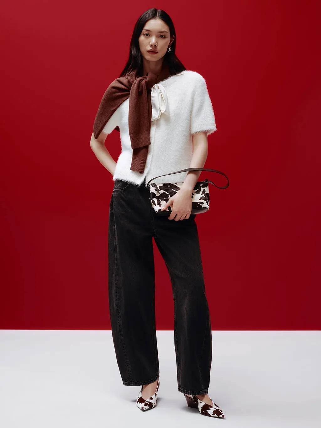 White Fuzzy Sweater with Black Wide Leg Jeans and Cow Print Bag — Trendy Party Outfits