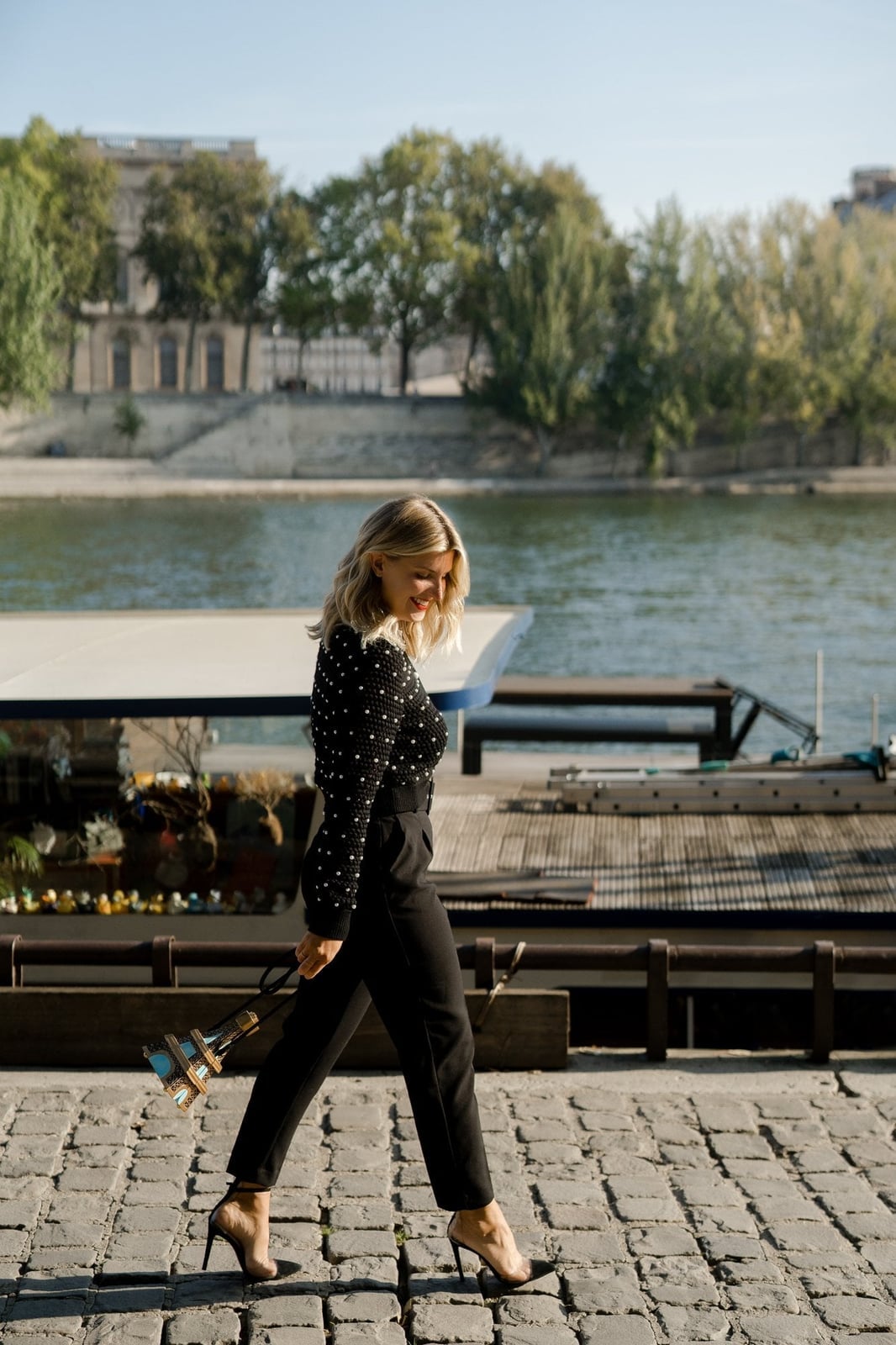 Polka Dot Top and Black Trousers with Eiffel Tower Handbag — Trendy Photoshoot Outfits